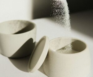 sugar being poured into a bowl